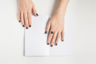 Close-up of woman hand over white background