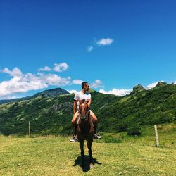 Full length of friends on mountain against sky