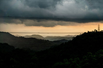 Scenic view of silhouette landscape against sky at sunset