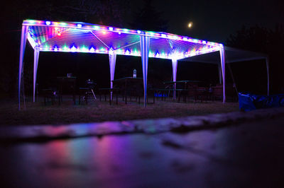 Empty chairs and tables at night