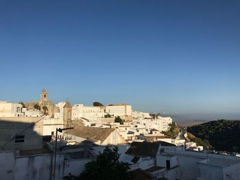 High angle view of buildings against clear blue sky