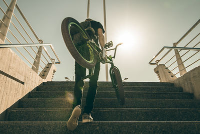 Low angle view of man on staircase against sky