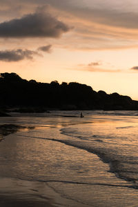 Scenic view of beach against sky during sunset
