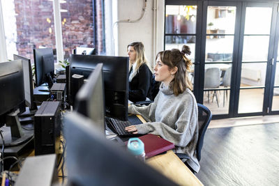 Businesswomen working on desktop pc in office
