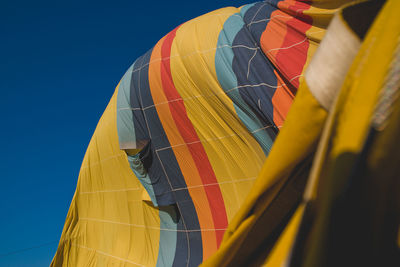 Low angle view of hot air balloon against blue sky