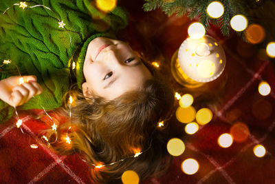 High angle view of girl lying on bed