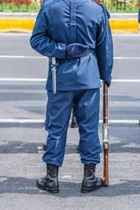 Rear view of man standing on road