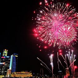Low angle view of firework display at night