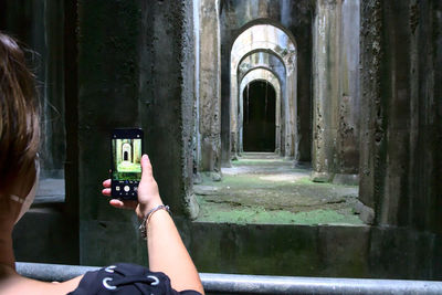 Woman photographing with mobile phone