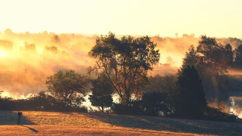 Scenic view of landscape against sky at sunset