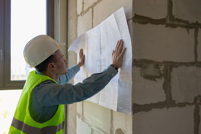 Side view of man using mobile phone