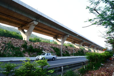 Road by bridge against clear sky