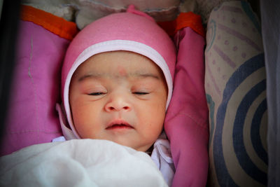 Portrait of cute new born baby girl in pink outfit.... in sleeping mood