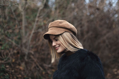 Portrait of young woman wearing hat