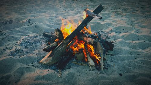 High angle view of bonfire on beach during sunset