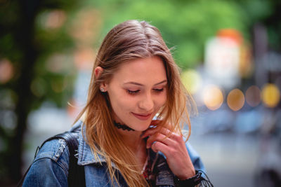 Portrait of young woman looking away outdoors