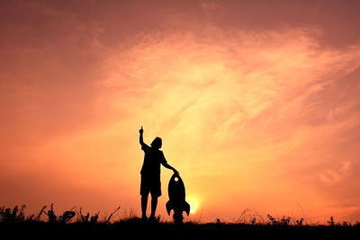 Silhouette of people at sunset