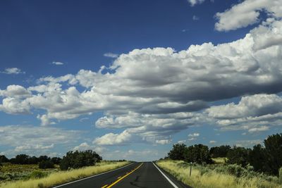 Empty road along countryside landscape