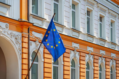 Low angle view of flags hanging on building