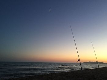 Scenic view of sea against clear sky at sunset