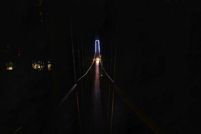 Light trails on bridge in city at night