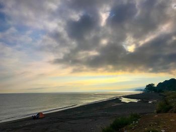 Scenic view of sea against dramatic sky