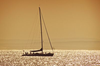 Sailboat sailing on sea against sky