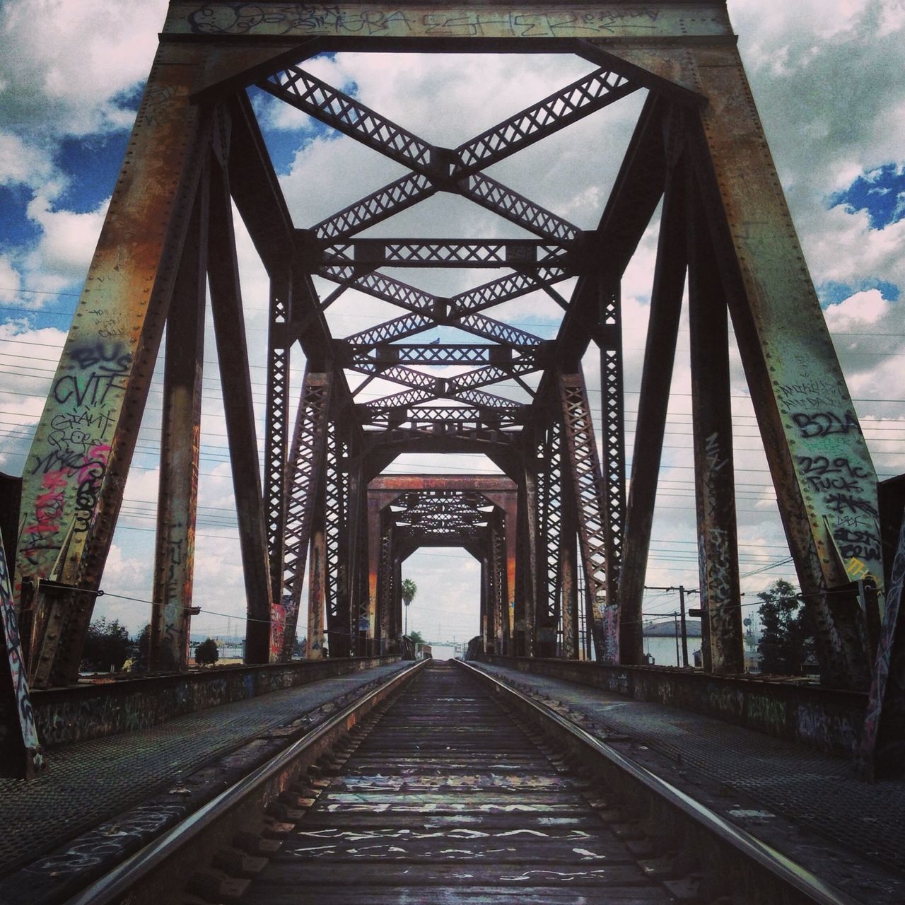 connection, the way forward, built structure, bridge - man made structure, architecture, diminishing perspective, transportation, sky, vanishing point, engineering, cloud - sky, metal, long, bridge, railway bridge, cloudy, metallic, cloud, low angle view, day