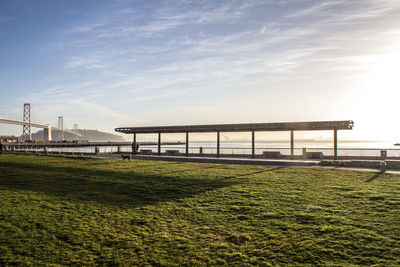 Bridge over grass against sky