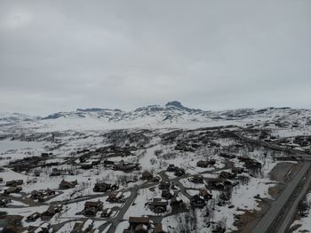 Aerial view of snowcapped mountains against sky