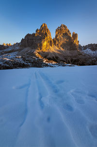 Scenic view of snow covered land against blue sky