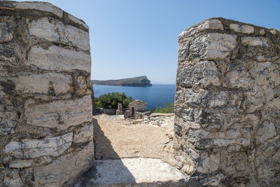 View of stone wall with sea in background