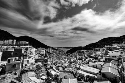 High angle view of houses in town against sky