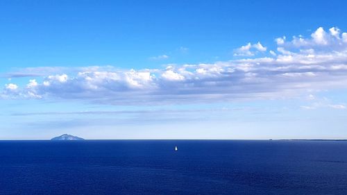 Scenic view of sea against blue sky