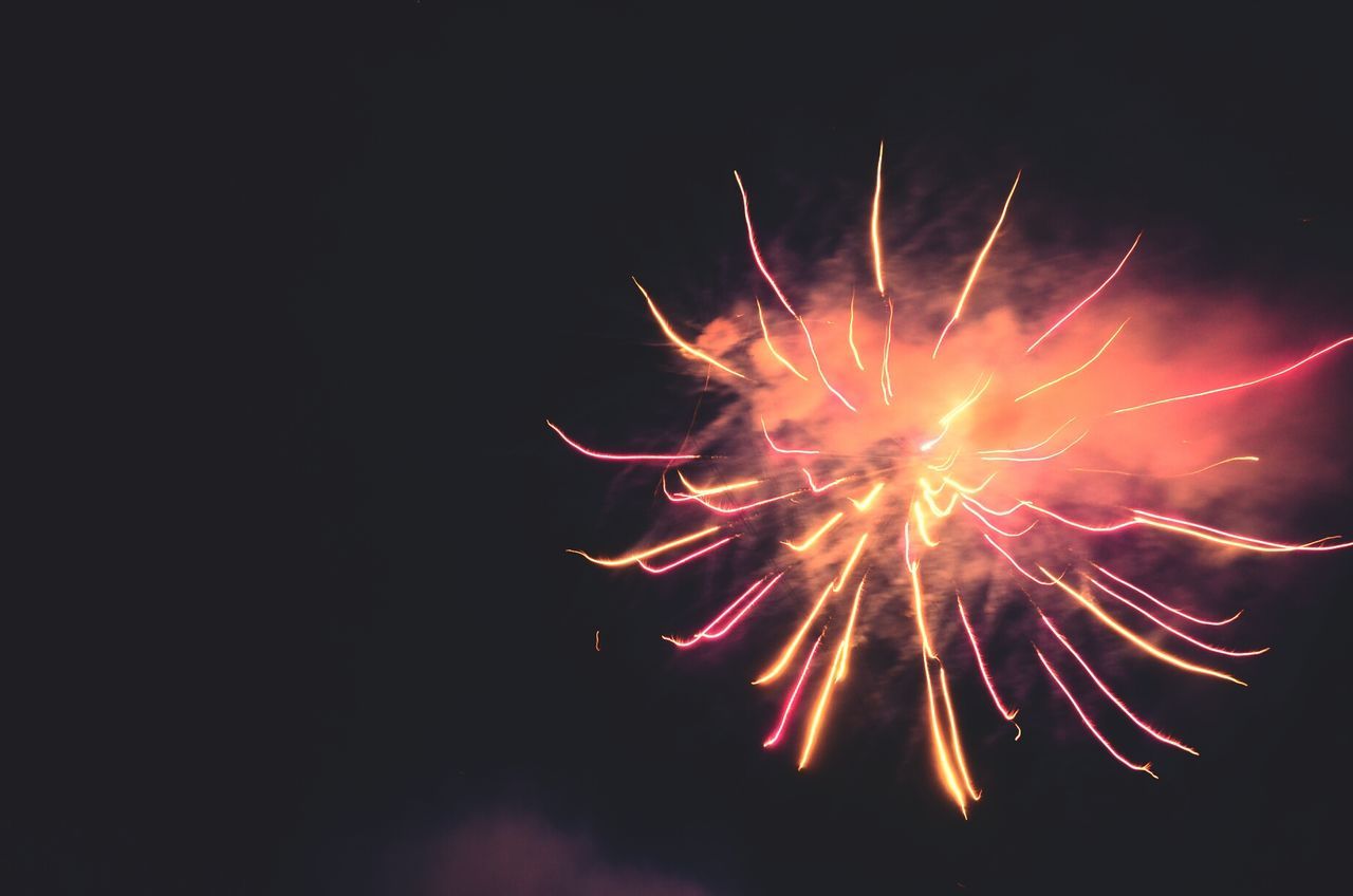 night, firework display, exploding, celebration, long exposure, firework - man made object, motion, glowing, illuminated, sparks, event, firework, arts culture and entertainment, low angle view, blurred motion, entertainment, sky, multi colored, fire - natural phenomenon, celebration event