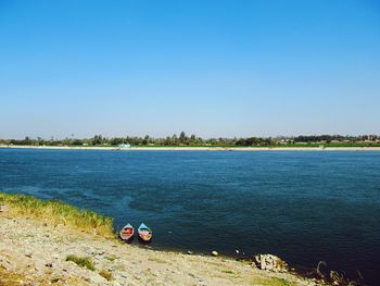 Scenic view of nile river against clear blue sky