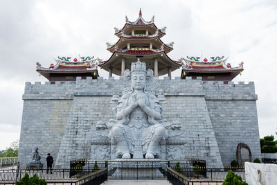 Statue of temple against building