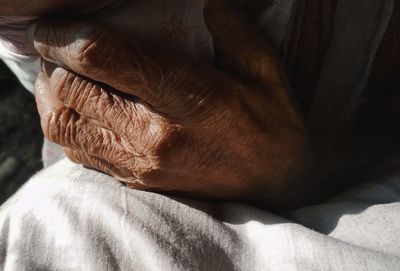 Close-up of man relaxing on hand