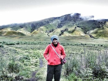 Rear view of woman standing in front of mountains