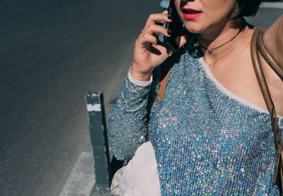 Midsection of woman talking on mobile phone