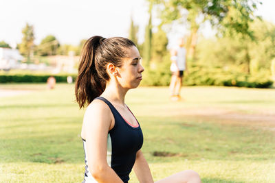 Woman looking away on field