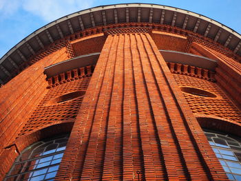 Low angle view of water tower building against blue sky