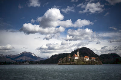 Scenic view of sea and mountains against sky