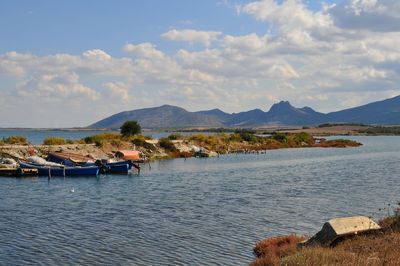 Scenic view of coastline against cloudy sky