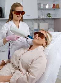 Female doctor examining patient in hospital