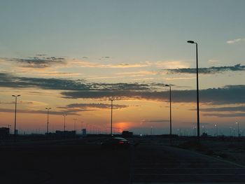 Street against sky during sunset