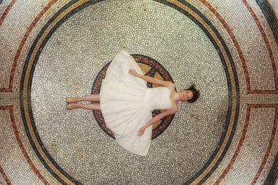 High angle view of woman lying down on floor