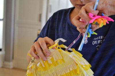 Midsection of woman holding flower