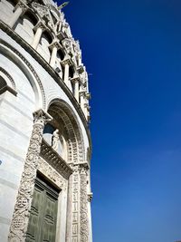 Low angle view of historical building against blue sky