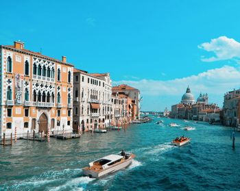 View of boats in canal against buildings